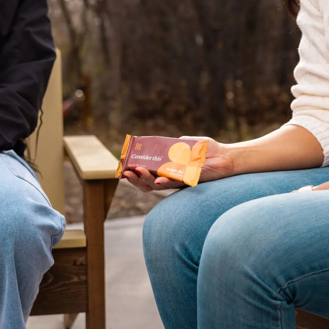 image of three people sitting around a fire enjoying the low histamine protein bars